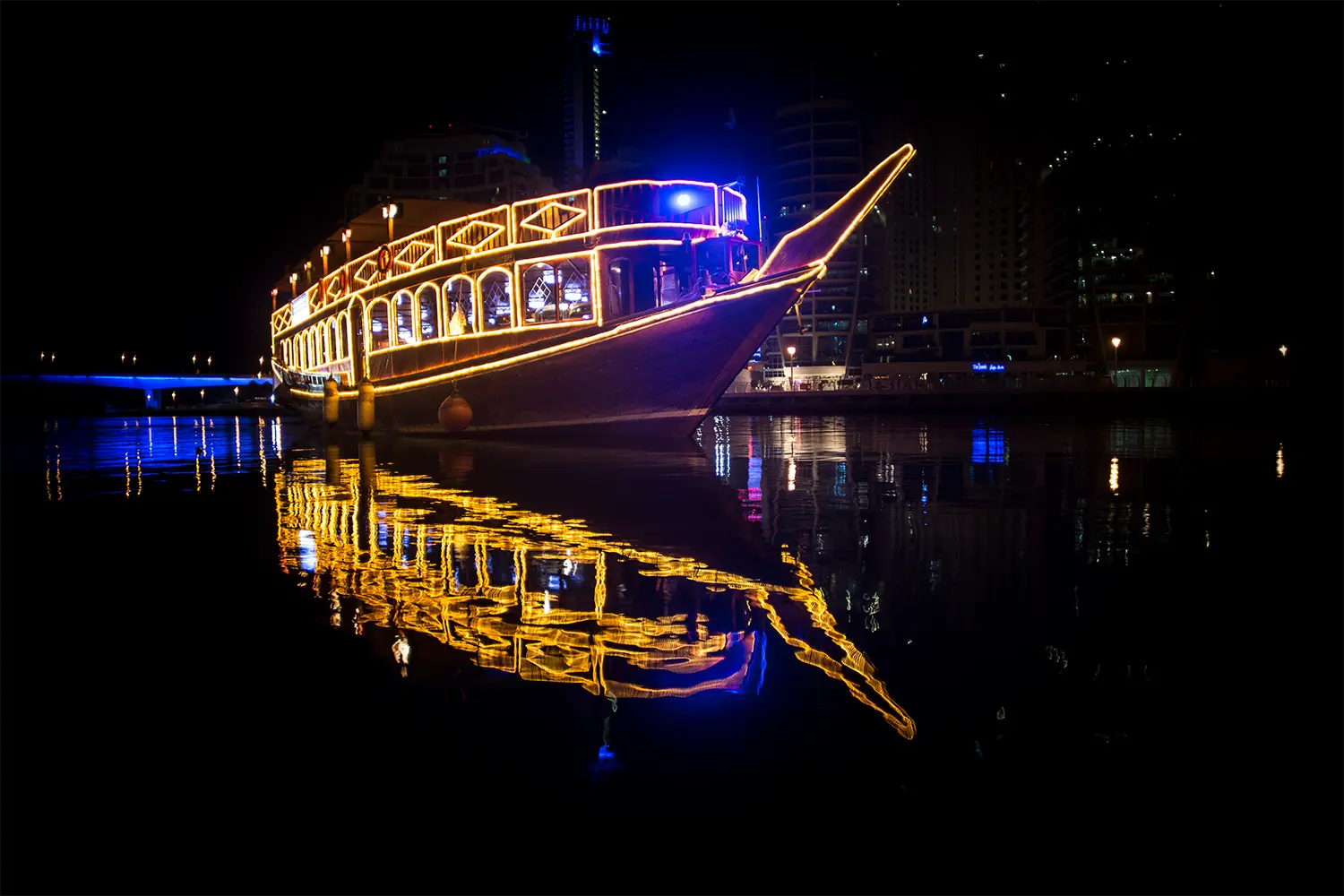 Luxury dinner cruise yacht sailing in Dubai Marina at night