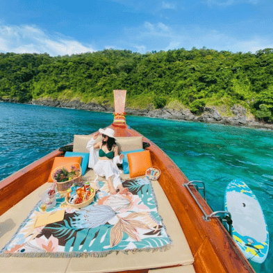 Floating breakfast served aboard a traditional Thai longtail boat in Phang Nga Bay, Thailand