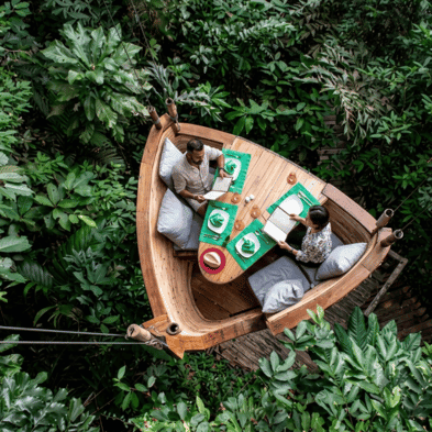 Gourmet dining suspended above the rainforest canopy in Soneva Kiri's bamboo Treepod, Trat, Thailand