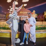 Image of family posing to photo in warner bros. world with big bunny entertainer