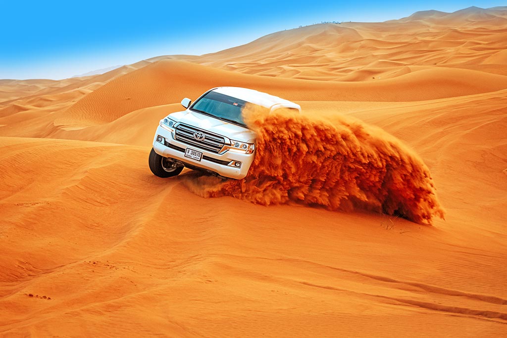 image of safari car in desert in Dubai, Abu Dhabi taking tourist for desert safari