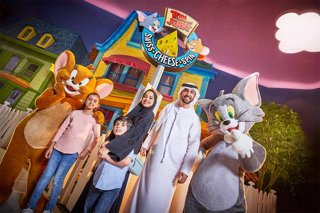 Image of Tom & Jerry & family in the warner bros. world posing for the photo