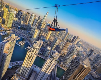 XLine-Dubai-Marina with tourist enjoying the zip line with a beautiful buildings view