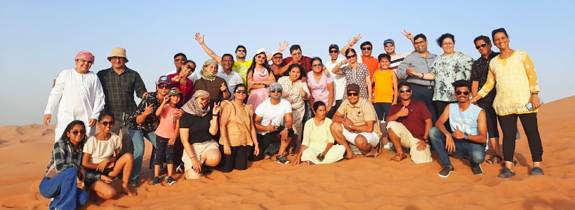 Tourists in Dubai Group Tour posing for the photo after Desert safari